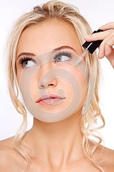 Woman applying serum