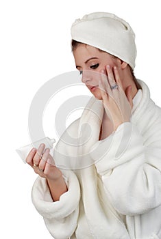 Woman applying skin lotion