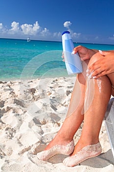 Woman applying sun blocker