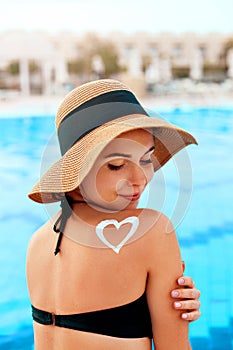 Woman Applying Sun Cream Creme on Tanned  Shoulder. Sun Protection.Sun Cream. Skin and Body Care.