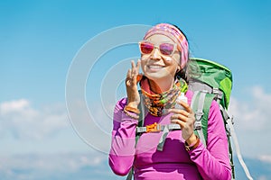Woman applying sun cream to protect her skin from dangerous uv sun rays high in mountains. Travel healthcare concept