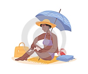 Woman applying sun lotion on beach