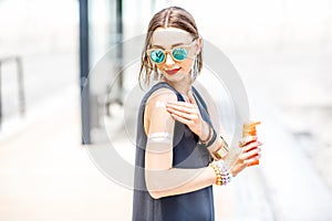 Woman applying sunscreen lotion