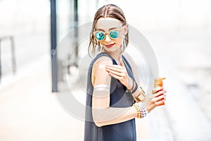 Woman applying sunscreen lotion photo