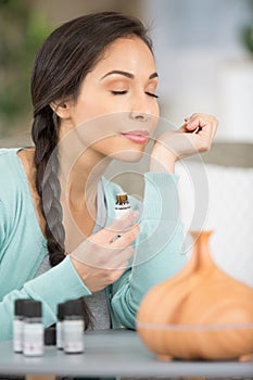 woman appreciating scent essential oil