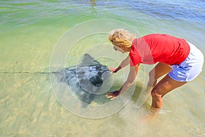 Woman approaches Eagle Ray