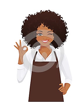 Woman in apron gesturing ok sign photo