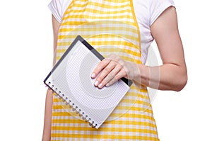 Woman in apron in hands notebook recipes