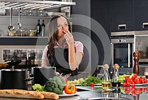 Woman in apron on modern kitchen