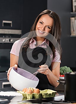 Woman in apron on a modern kitchen