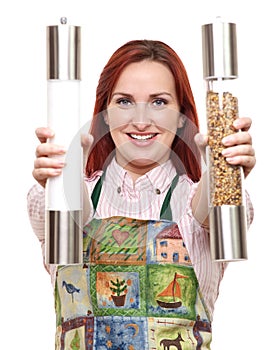 Woman in apron with salt and pepper