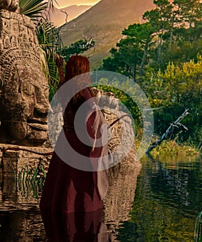 Woman archer with an arrow and bow in front of a temple in the jungle