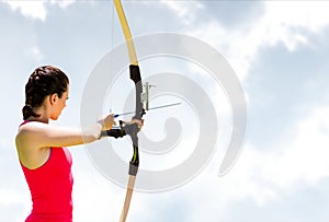 Woman archery against sky