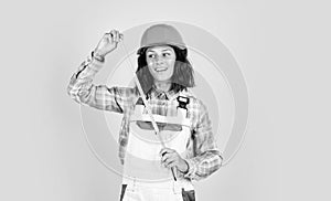 woman architect in helmet. girl in checkered shirt and protective hard hat. building and construction site. Builder