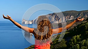 Woman arm in the air front of beautiful landscape- tourism, travel concept
