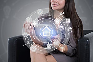 Woman in armchair with tablet, smart home