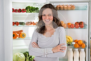 Woman With Armcrossed In Front Of Fridge