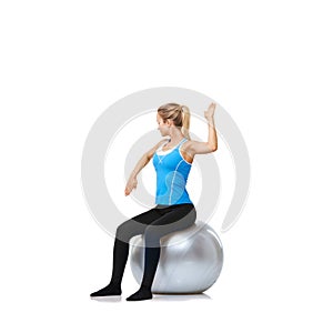 Woman, arms or ball balance on a white background space for workout, wellness or mobility exercise. Female athlete