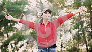 Woman arms outstretched in nature