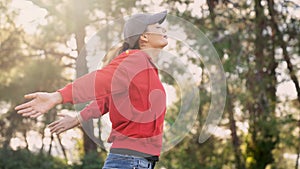 Woman arms outstretched in nature