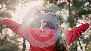 Woman arms outstretched in nature