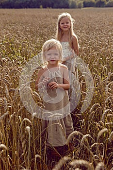 Woman with arms outstretched in a wheat field