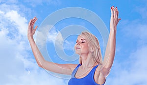 Woman with arms raised and closed eyes