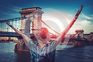 Woman arms raised in sunrise at Budapest, Hungary