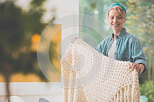 Woman is arranging white coverlet photo