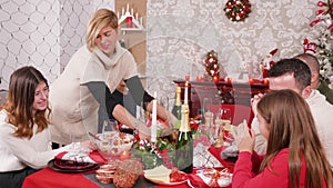 Woman arriving with delicious turkey on christmas family dinner