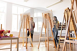 Woman artists or students painting at art school