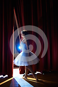 Woman as classic dancer looking at stalls before ballet