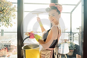 Woman as homemaker at spring clean working on the windows