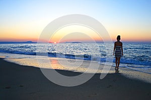 Woman as silhouette on the beach