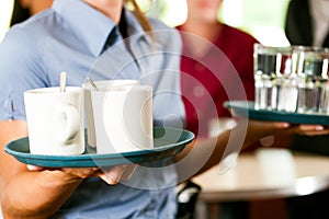 Woman as waitress in a bar or restaurant