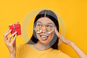 woman with Asian appearance fashion glasses gift holiday close-up studio model unaltered