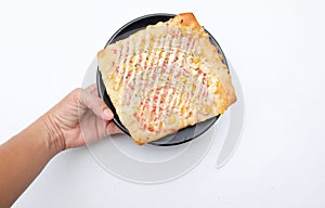 woman asian hand holding a Appetizing Homemade pizza bread with ketchup, mayonnaise, boiled corn sausage and cheese