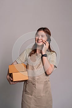 Woman asian holding box package and smartphone isolated on white background