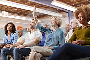 Woman Asking Question At Neighborhood Meeting In Community Center photo