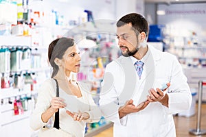 Woman asking questions about medicine, druggist consultation