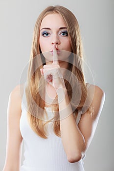 Woman asking for silence finger on lips