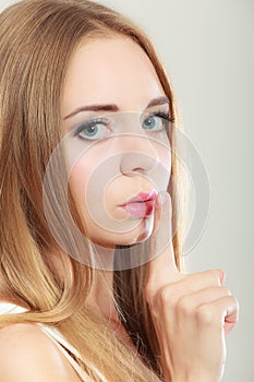 Woman asking for silence finger on lips