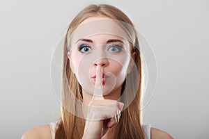 Woman asking for silence finger on lips