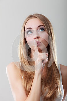 Woman asking for silence finger on lips