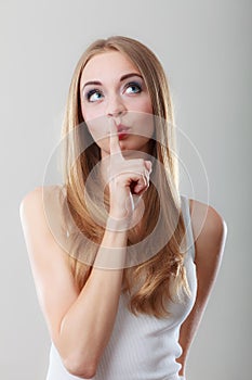 Woman asking for silence finger on lips