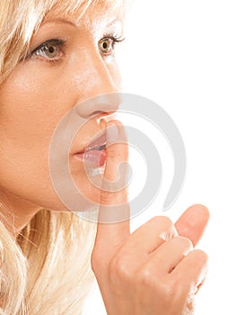 Woman asking for silence finger on lips hush gesture.