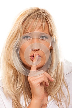 Woman asking for silence finger on lips hush gesture.