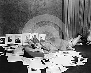 Woman asleep on floor surrounded by illustrations