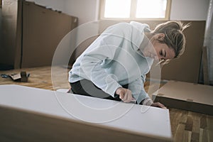 Woman assembling furniture