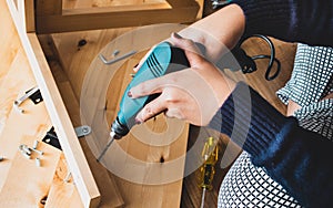 Woman assembly wooden furniture,fixing or repairing house